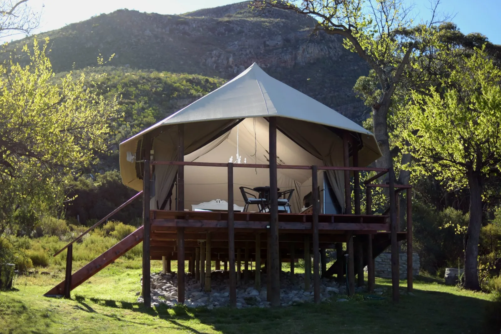 Oakron's cream canvas tent and timber deck beneath old oak trees